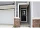 Close-up of the front door with brick accents and the house number '2704' at 2704 Grassy Br Dr, Whitestown, IN 46075