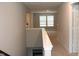 A hallway with neutral walls and carpet leading to multiple rooms at 2704 Grassy Br Dr, Whitestown, IN 46075