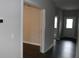 Hallway with dark wood floors, neutral paint, and doorways leading to other rooms at 2704 Grassy Br Dr, Whitestown, IN 46075