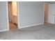 Bedroom features carpet and an open entrance to the ensuite bathroom at 2704 Grassy Br Dr, Whitestown, IN 46075