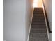 Carpeted stairway with stained handrail, leading to the upper level of the home at 2704 Grassy Br Dr, Whitestown, IN 46075