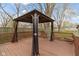 This is a cozy back deck with a dark brown gazebo featuring black curtains at 304 W 4Th St, Greenfield, IN 46140