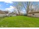 This spacious lawn has a detached garage and mature trees and a view of other homes at 304 W 4Th St, Greenfield, IN 46140