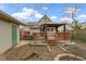 This backyard has a wood deck with gazebo, hot tub, green garage, and fire pit at 304 W 4Th St, Greenfield, IN 46140
