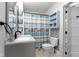 Modern bathroom with a stylish vanity and mosaic tiling, featuring sleek fixtures and convenient shelving at 304 W 4Th St, Greenfield, IN 46140