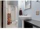 Bright bathroom featuring a pedestal sink, toilet, and shower with colorful curtain at 304 W 4Th St, Greenfield, IN 46140