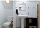 Bathroom featuring a pedestal sink, toilet, and mirrored vanity at 304 W 4Th St, Greenfield, IN 46140