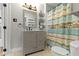 Updated bathroom features a stylish vanity, storage, and a shower with a decorative curtain for added privacy at 304 W 4Th St, Greenfield, IN 46140