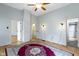 Spacious bedroom with original hardwood floors and a decorative rug, featuring access to multiple rooms and ample light at 304 W 4Th St, Greenfield, IN 46140