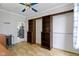 Bedroom with built-in shelving, access to kitchen, ceiling fan, and bright lighting at 304 W 4Th St, Greenfield, IN 46140