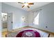 Inviting bedroom with a large window and decorative rug, featuring a connected bathroom and convenient closet at 304 W 4Th St, Greenfield, IN 46140