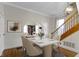 Elegant dining room with a marble-top table, stylish chairs, and access to a living room through an arched entryway at 304 W 4Th St, Greenfield, IN 46140