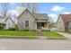 Charming two-story home featuring a well-manicured lawn, inviting front porch, and classic architectural details at 304 W 4Th St, Greenfield, IN 46140