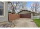 This is an attached garage featuring a brown garage door and a concrete driveway at 304 W 4Th St, Greenfield, IN 46140