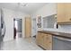 Bright eat-in kitchen featuring light wood cabinets, stainless steel dishwasher, and tile floors at 304 W 4Th St, Greenfield, IN 46140