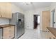 Eat-in kitchen featuring a stainless steel refrigerator, light wood cabinetry, and tiled flooring at 304 W 4Th St, Greenfield, IN 46140