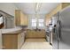 Eat-in kitchen with bright lighting, light wood cabinetry, and stainless steel appliances at 304 W 4Th St, Greenfield, IN 46140