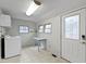 Bright laundry room with a washing machine, a table and a door to the outside at 304 W 4Th St, Greenfield, IN 46140