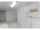 Bright laundry area featuring a washing machine, dryer, and white cabinetry at 304 W 4Th St, Greenfield, IN 46140