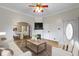 Cozy living room featuring hardwood floors, a fireplace, a TV, and an open layout to the dining area at 304 W 4Th St, Greenfield, IN 46140