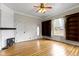 Bright living room boasts wood floors, built-in shelving, a decorative fireplace, and large windows for ample natural light at 304 W 4Th St, Greenfield, IN 46140