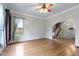 Open-concept living room features beautiful wood floors, archway access to the kitchen, and stairs to the upper level at 304 W 4Th St, Greenfield, IN 46140