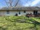 Exterior of the home showing siding, windows, air conditioning unit, and access to the deck and backyard at 3102 Pawnee Dr, Indianapolis, IN 46235