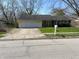 Inviting one-story home featuring a two-car garage, well-maintained lawn, and classic suburban appeal at 3102 Pawnee Dr, Indianapolis, IN 46235