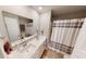 Bathroom featuring a double vanity, a large mirror, and a shower with a patterned curtain at 3117 Allesley Way, Westfield, IN 46074