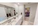 Bathroom features double sinks, a large mirror, and a walk-in closet for organized storage at 3117 Allesley Way, Westfield, IN 46074