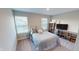 Bedroom with two windows, a comfortable bed with decorative pillows, and a TV with shelving at 3117 Allesley Way, Westfield, IN 46074
