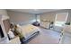 Bright bedroom boasts neutral colors, a large bed, a dresser, and windows for natural light at 3117 Allesley Way, Westfield, IN 46074