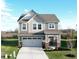 Charming two-story home boasts a well-manicured lawn, a two-car garage, and classic architectural details at 3117 Allesley Way, Westfield, IN 46074