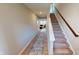 Bright and open hallway featuring sleek flooring and a staircase, connecting the home's living spaces seamlessly at 3117 Allesley Way, Westfield, IN 46074