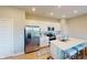 Modern kitchen features stainless steel appliances, white cabinetry, quartz countertops, and a breakfast bar at 3117 Allesley Way, Westfield, IN 46074