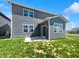 The backyard of the home features lush green grass, modern siding, and a concrete patio at 3278 Jasper Ln, Brownsburg, IN 46112