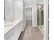 A pristine bathroom featuring a double vanity, walk-in shower, and access to a spacious walk-in closet at 3278 Jasper Ln, Brownsburg, IN 46112