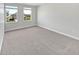 Bedroom boasts plush carpet, neutral walls, and natural light from two windows showcasing the neighborhood at 3278 Jasper Ln, Brownsburg, IN 46112