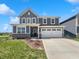 Charming two-story home with a manicured lawn, inviting curb appeal, and attached two car garage at 3278 Jasper Ln, Brownsburg, IN 46112