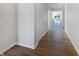 A pristine hallway featuring hardwood floors, crisp white walls, and an abundance of natural light at 3278 Jasper Ln, Brownsburg, IN 46112