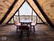 Charming attic features a wooden table with chairs and open air balcony overlooking wooded area at 3559 N Us Highway 41, Bloomingdale, IN 47832