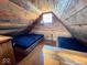 Rustic attic bedroom features two beds, wood-paneled walls, and natural light from the window at 3559 N Us Highway 41, Bloomingdale, IN 47832