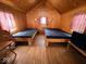 Cozy cabin interior featuring twin beds and wood paneled walls and ceiling at 3559 N Us Highway 41, Bloomingdale, IN 47832