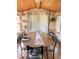 Bright dining area with wood-paneled ceiling, round table, and natural light at 3559 N Us Highway 41, Bloomingdale, IN 47832