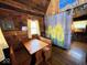 Rustic dining area with a wooden table and bench seating, lit by a charming window at 3559 N Us Highway 41, Bloomingdale, IN 47832