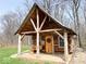 Quaint log cabin with a covered porch, wooden bench, and rustic charm at 3559 N Us Highway 41, Bloomingdale, IN 47832