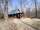 Secluded cabin with metal roof and porch set amongst trees, offering a peaceful retreat in nature at 3559 N Us Highway 41, Bloomingdale, IN 47832