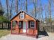 Charming wooden cabin with a blue roof and cozy front porch at 3559 N Us Highway 41, Bloomingdale, IN 47832