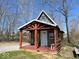 Charming cabin with a porch and red accents, surrounded by greenery and offering a tranquil setting at 3559 N Us Highway 41, Bloomingdale, IN 47832