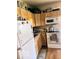 Efficient kitchen featuring natural wood cabinets and modern white appliances at 3559 N Us Highway 41, Bloomingdale, IN 47832